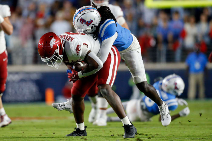 Oct 7, 2023; Oxford, Mississippi, USA; Arkansas Razorbacks tight end Ty Washington (8) catches the ball as Mississippi Rebels defensive back DeShawn Gaddie Jr. (9) make the tackle during the first half at Vaught-Hemingway Stadium. Mandatory Credit: Petre Thomas-USA TODAY Sports